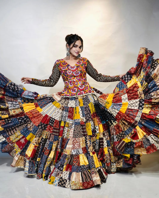 Multicolour Mix Fabric Chaniya With Grand 8-Meter Flair Paired With Detailed Kachhi Work Blouse.