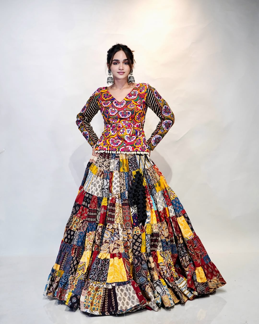 Multicolour Mix Fabric Chaniya With Grand 8-Meter Flair Paired With Detailed Kachhi Work Blouse.
