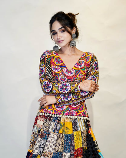 Multicolour Mix Fabric Chaniya With Grand 8-Meter Flair Paired With Detailed Kachhi Work Blouse.